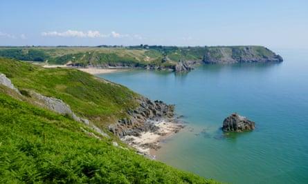 Walking to Three Cliffs Bay from Pennard on a sunny, blue-sky day. Wales, UK.